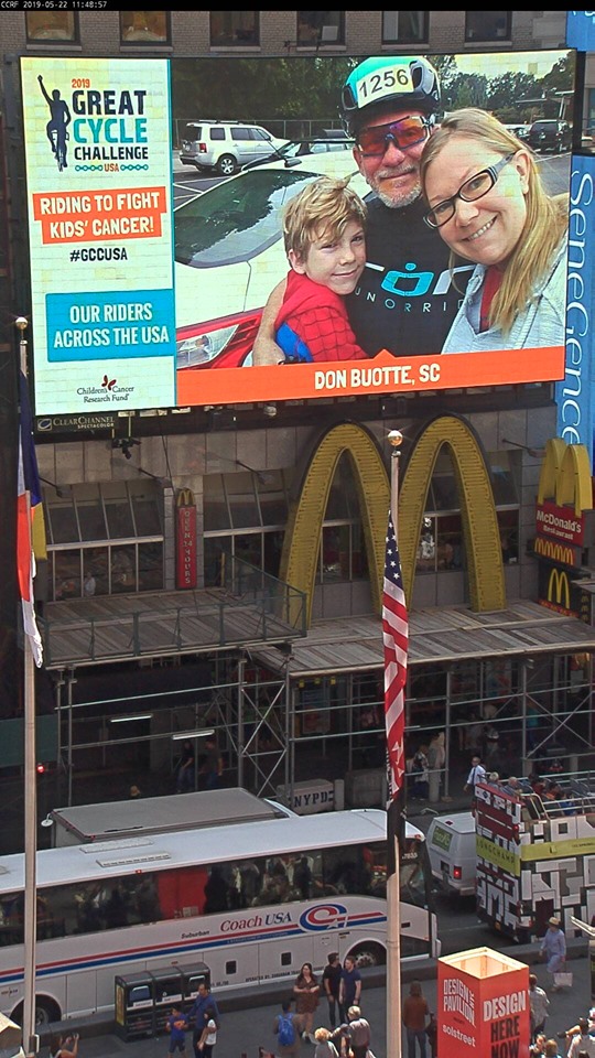 Picture of Don Buotte on large monitor in Times Square